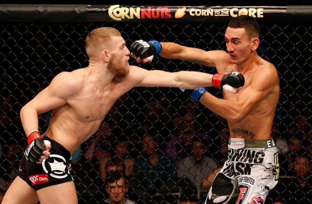 Conor McGregor and Max Holloway during their first fight in Boston in 2013